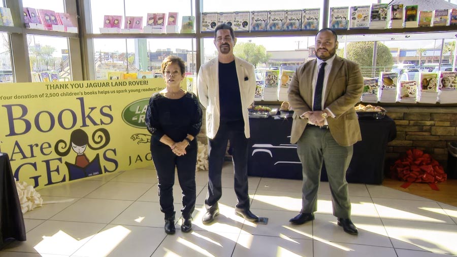 Land Rover of El Paso Donates 2,500 Children’s Books. Three people in book store during charity event.
