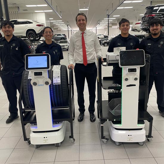 Finley Ewing IV, CEO of Ewing Automotive Group and TADA Board Member, at his Mercedes-Benz of Plano location with the hard-working technicians and an amazing team of robots.